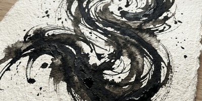 Black ink swirl abstract painting on textured white paper